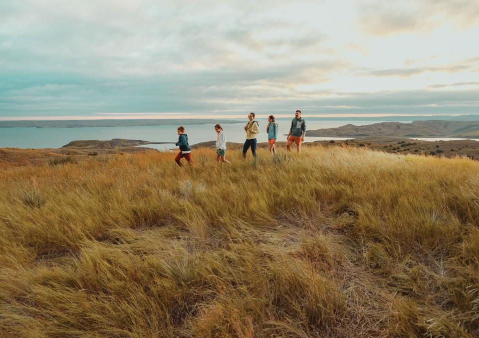 2026 Marketing Campaign --- people walking along the river